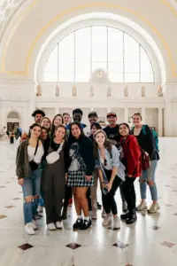 Group of students at the Baltimore Urban Studies program posing in capital