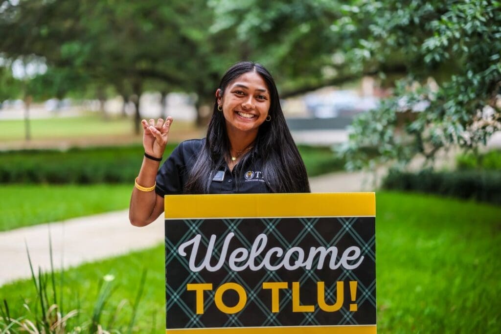 TLU student greeting visitors