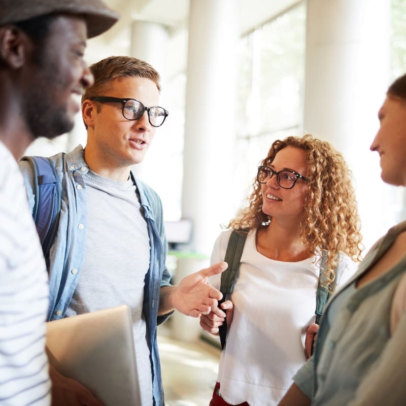 Stock image of four students chatting
