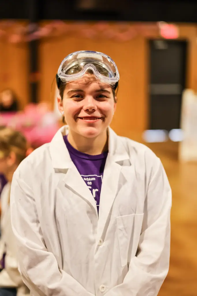 student in lab coat and goggles