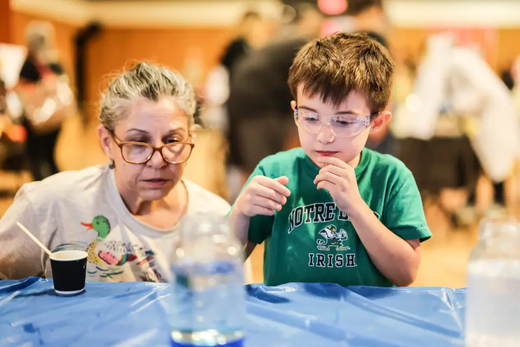 parent and child looking at experiment