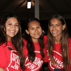 three campus activity girls smiling and posing for the picture