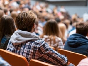 A group of students in a lecture hall.