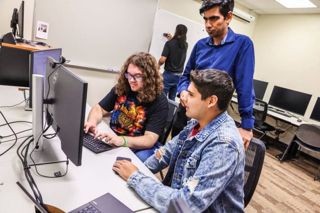 students with their professor in a computer lab